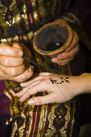 Arabian tattoo with earth colour being applied onto a hand, Tunisia, Africa