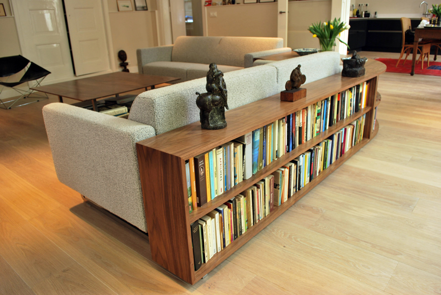 Low walnut bookcase behind sofa - Jeroen Kool