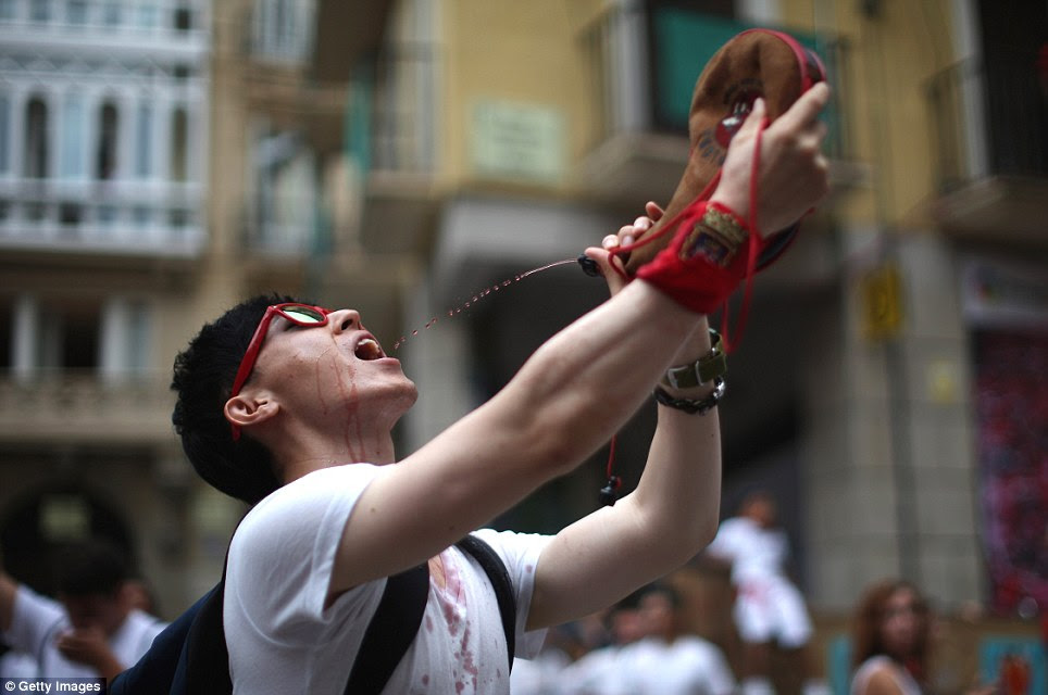 Cheers: Revellers throw wine during the first day of the 14-day festival made famous by the 1926 novel of US writer Ernest Hemingway