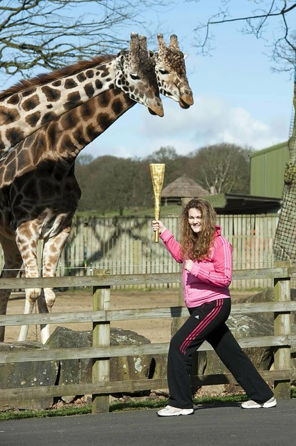 Teenage torchbearer takes Olympic Flame into Safari Park.