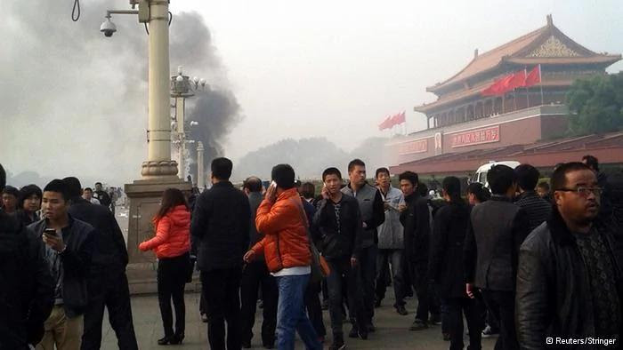 People walk along the sidewalk of Chang