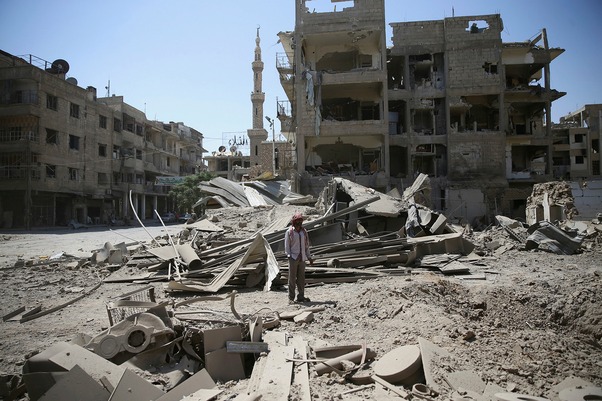 A man stands amid the damage after an airstrike in the rebel held Douma neighbourhood of Damascus, Syria August 22, 2016. REUTERS/Bassam Khabieh