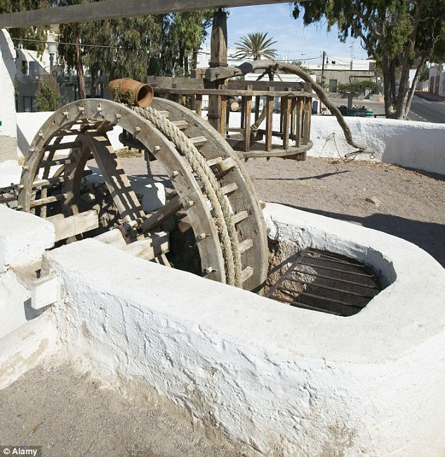 Falling in love: A half-naked woman had to be rescued by firefighters from the bottom of a waterwheel well like this one after plunging 15m into the water while having sex near a Spanish park