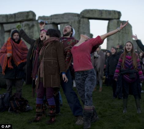 People react as they see the sun starting to rise on the horizon before its light hits them 