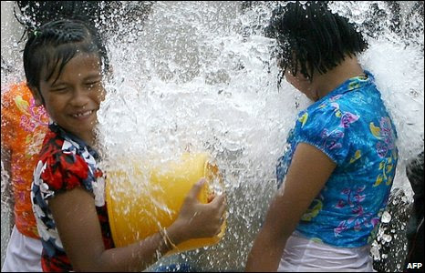 Thai Buddhist children play with water at a temple during a festival to mark Thai New Year.
