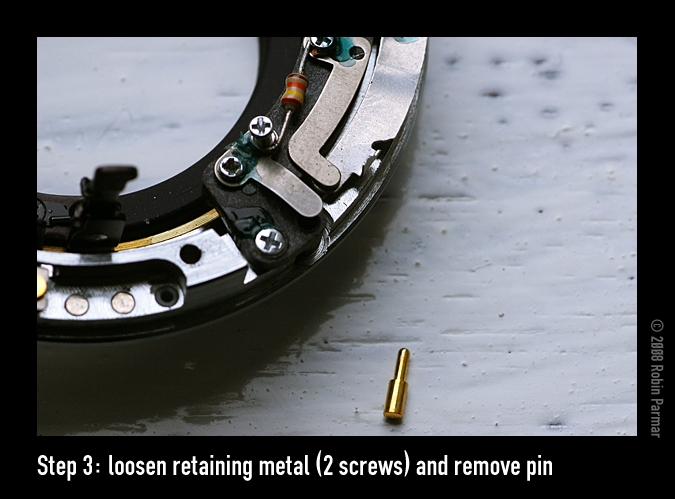 Step 3: loosen retaining metal (2 screws) and remove pin