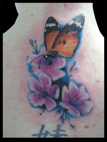 Girl with tattoo butterfly on cerry's flow 