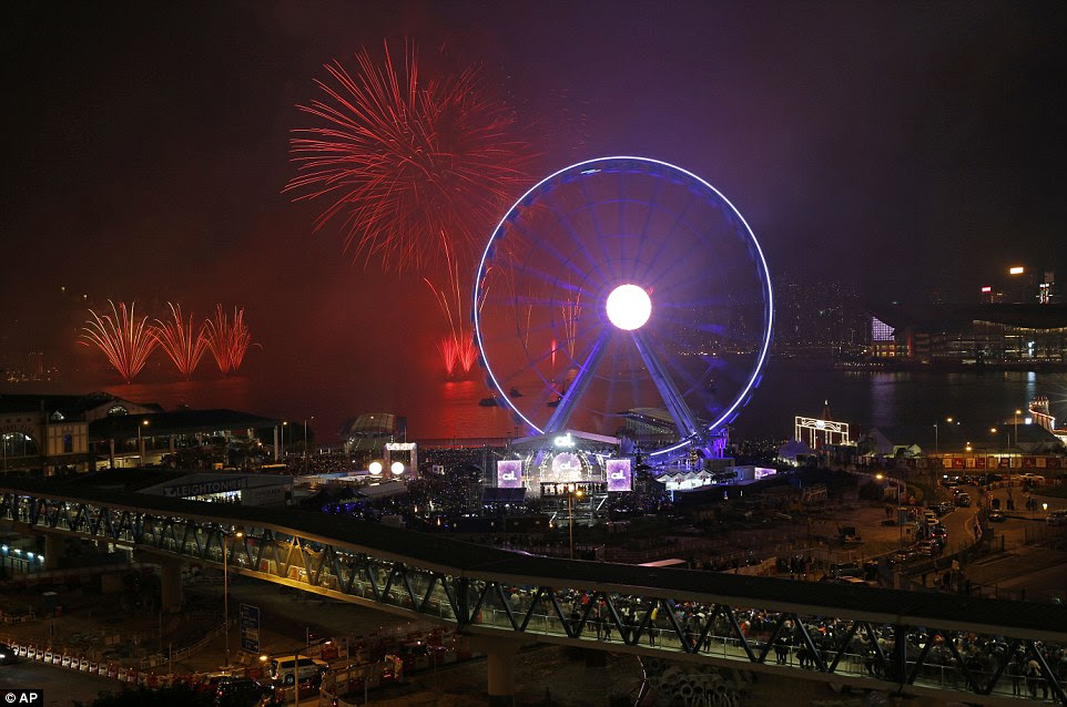 All over the globe: Fireworks explode over the Victoria Harbour as Hong Kong celebrates the arrival of 2015