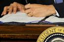 FILE - In this March 23, 2010, file photo President Barack Obama signs the health care bill in the East Room of the White House in Washington. As a hectic sign-up season winds down, President Barack Obama's health care law has managed to change the country. Americans are unlikely to go back to a time when people with medical problems could be denied coverage. But Obama’s overhaul needs reworking of its own to go down in history as a legacy achievement like Medicare and Social Security.(AP Photo/J. Scott Applewhite, File)