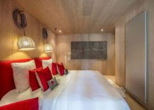 Pops of red enliven the chalet bedroom