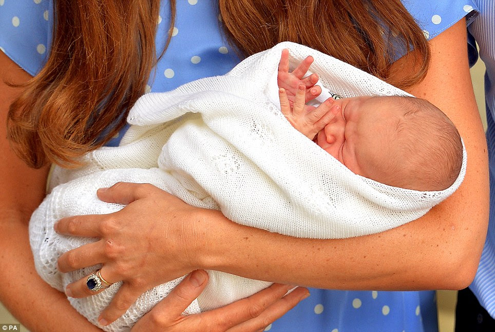 The safe hands of the Duchess of Cambridge with her son who was born on Monday, but was thrown into the spotlight yesterday