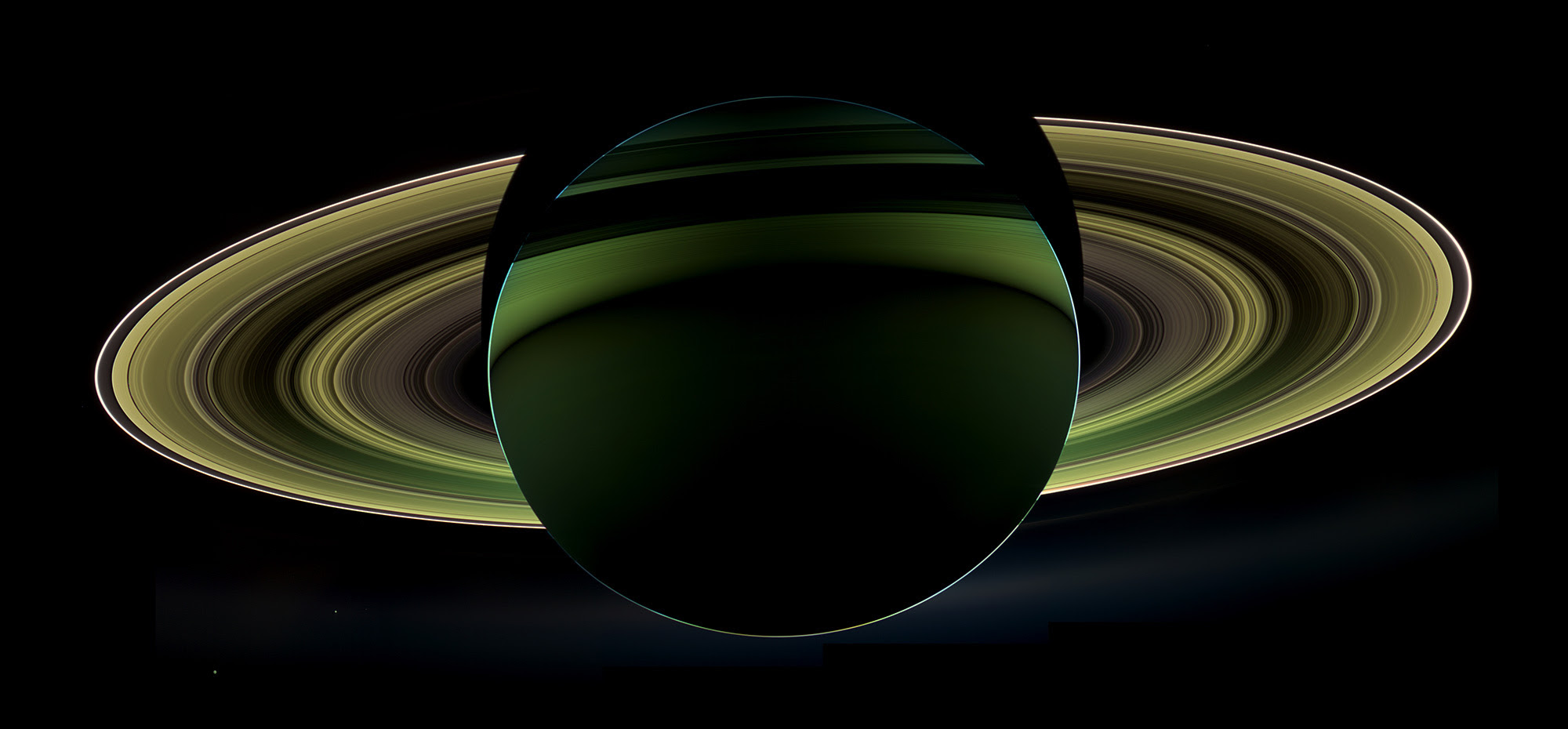 A Splendor Seldom Seen: Saturn, its rings, and moons, backlit by the Sun, seen by the Cassini orbiter as it passes in Saturn's shadow