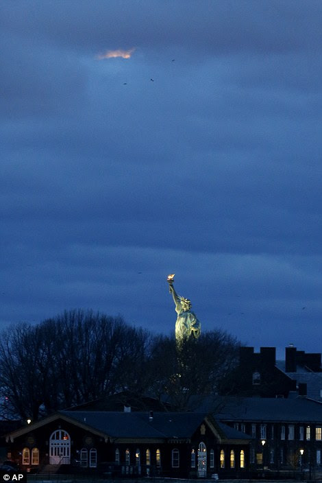 In New York, where the sun was rising, the sky glared orange from the reflection of the sun's rays from the moon