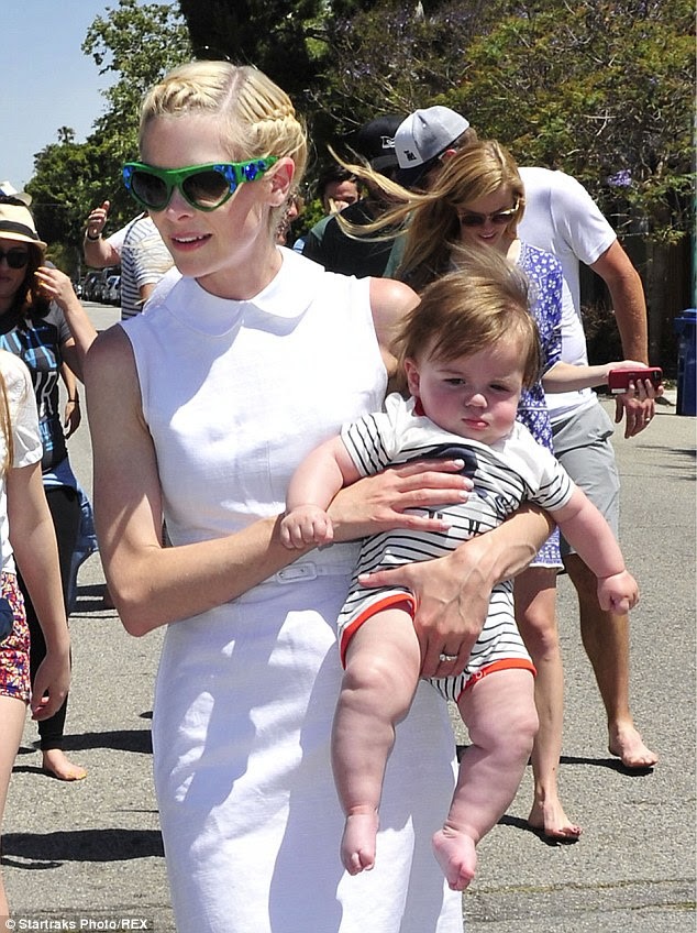 Children's charity: The 35-year-old actress - who had a mani-pedi Thursday - brought along her barefoot six-month-old son James, who looked ultra-cute in his striped onesie