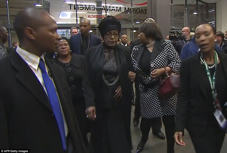 Mourning: Mr Mandela's former wife Winnie Mandela Madikizela (centre), who famously greeted her husband as he left prison, arrives at the ceremony
