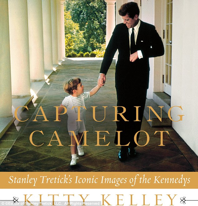 Iconic: JFK and his son John Jr stroll along the White House portico shortly after he was inaugurated as President
