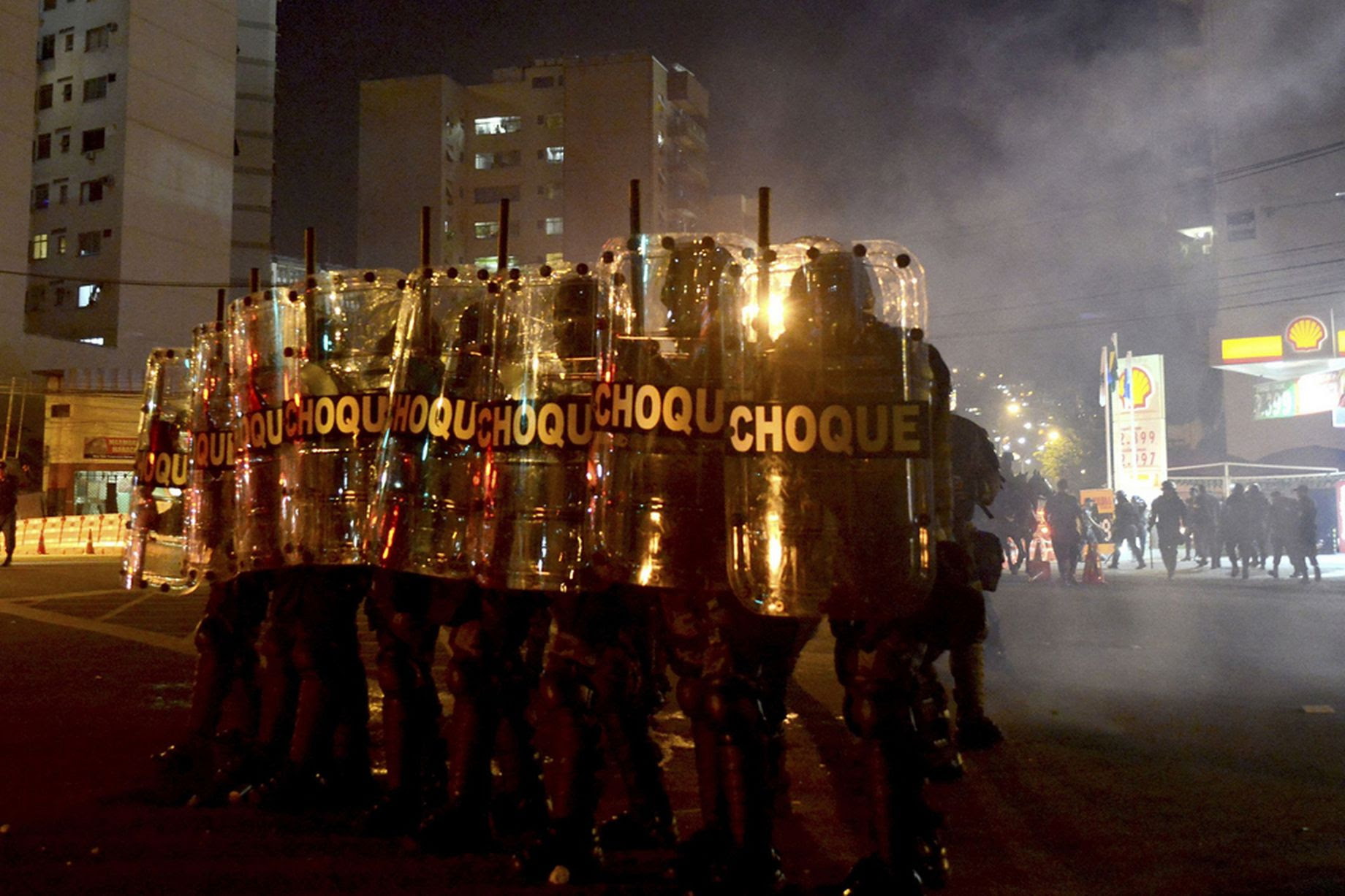 Riot police face protesters during a demonstration against the public spending for the 2014 World Cup, in Rio de Janeiro June 15, 2014.