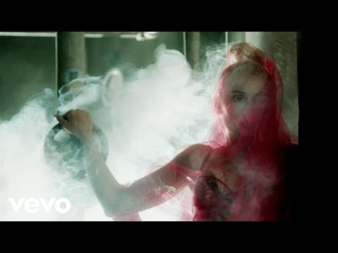 Gwen Stefani wears a corset and kinky boots as she sings about Blake Shelton during her "Misery" video