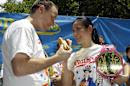 FILE - In this July 3, 2012, file photo, hot-dog eating champions Joey Chestnut, left, and Sonya "The Black Widow" Thomas pose for photographers at City Hall Park in New York, during a weigh-in for contestants in the annual Coney Island Fourth of July international hot-dog eating contest. The pair aim to take the crowns again at the annual Fourth of July contest on Coney Island.(AP Photo/Kathy Willens, File)