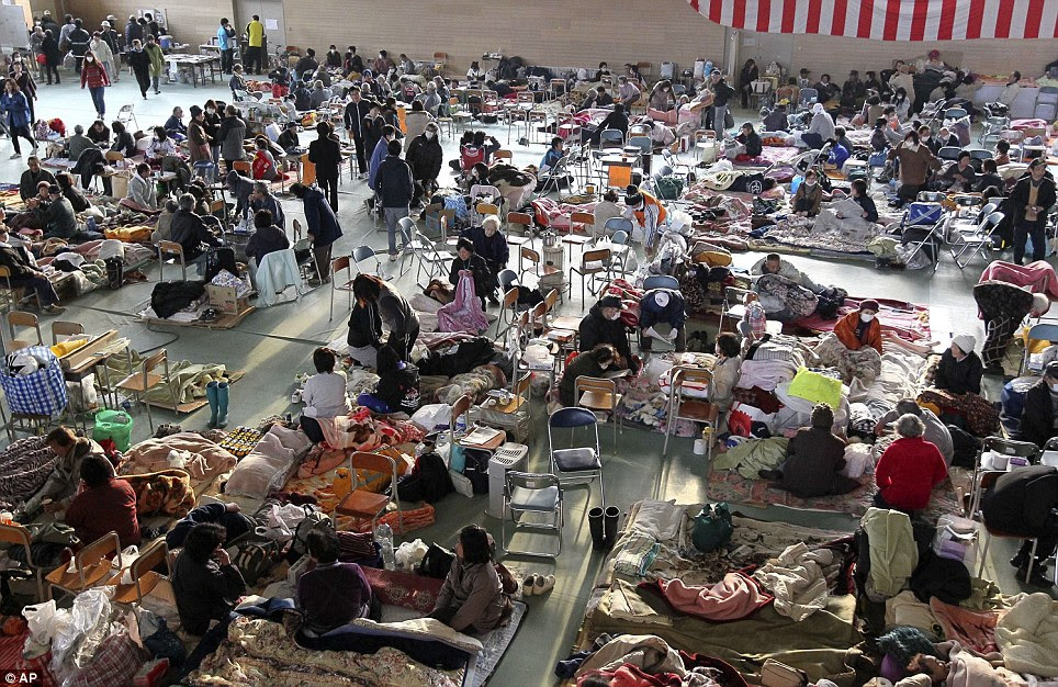 Struggle for survival: Survivors of Friday's earthquake and tsunami spend time at an evacuation center in Rikuzentakata in Iwate Prefecture