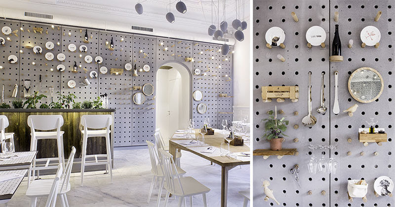 Wall Decor Idea - A gray perforated concrete pegboard lines the wall of this cafe for a unique shelving solution.