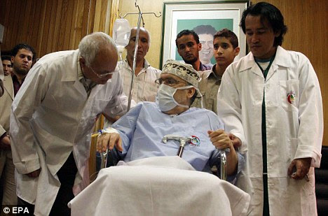 A senior Libyan official has confirmed that Megrahi (centre, pictured in a Tripoli hospital in September) is in 'good condition' 