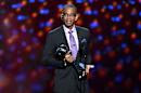 FILE - In a July 16, 2014 file photo, sportscaster Stuart Scott accepts the Jimmy V award for perseverance, at the ESPY Awards at the Nokia Theatre, in Los Angeles. Scott, the longtime “SportsCenter” anchor and ESPN personality known for his known for his enthusiasm and ubiquity, died Sunday, Jan. 4, 2015 after a long fight with cancer. He was 49. (Photo by John Shearer/Invision/AP, File)