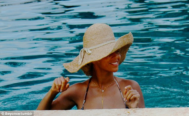 Shady lady: A floppy hat shielded Beyonce's face from the sun but not her bright smile
