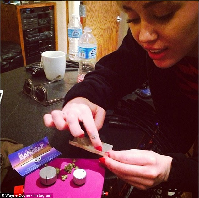Suspicious: Wayne Coyne posted a picture of Miley Cyrus on Friday with the caption 'Yup...... Recordin with Miley... High as f***'