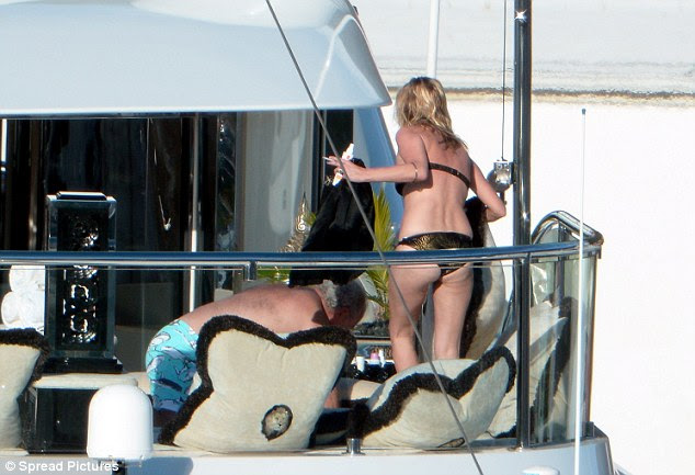 Kate Moss displays a Black Bikini around a Yacht in Saint Barthelemy