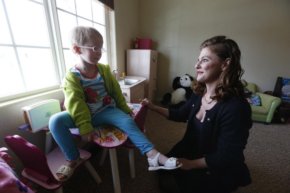 FILE - In this April 29, 2014 file photo, Moriah Barnhart, a mother of a child with severe cancer, sits with her three year old daughter Dahlia, who...