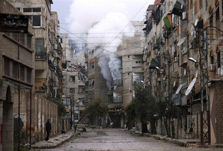 A man stands in an empty street near a burning building hit by a mortar shell fired by Syrian Army soldiers, in the Zamalka neighbourhood of Damascus February 6, 2013. REUTERS/Goran Tomasevic