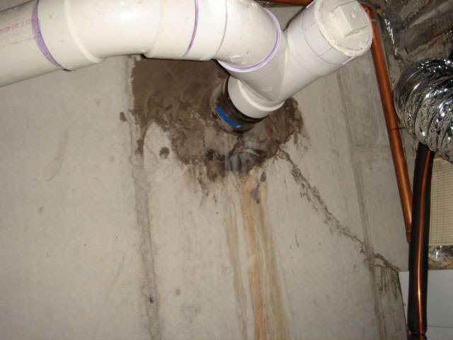 Water leak around pipe basement wall