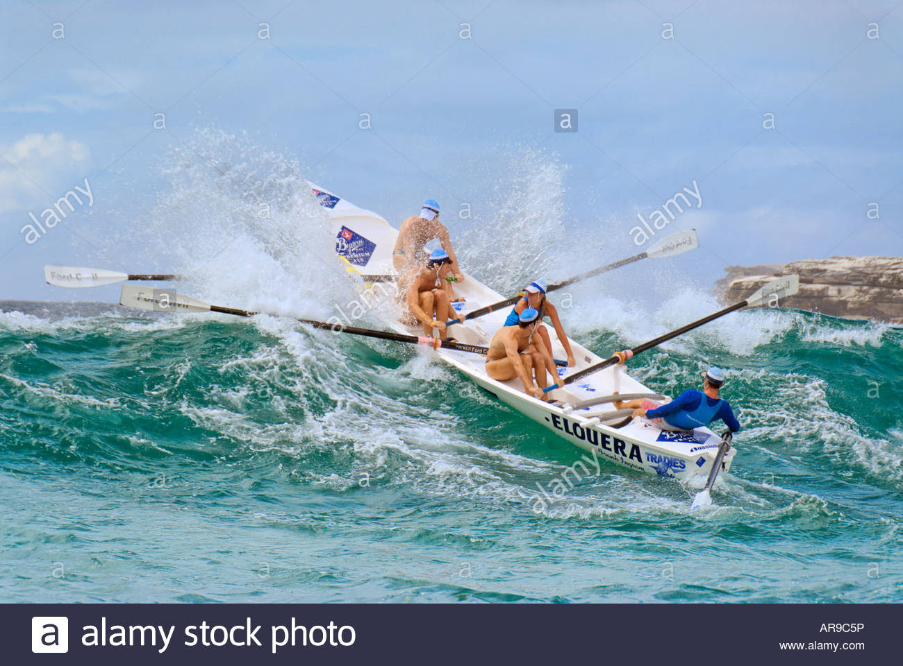 surf life saving rowing boat on wave at a surf carnival at 