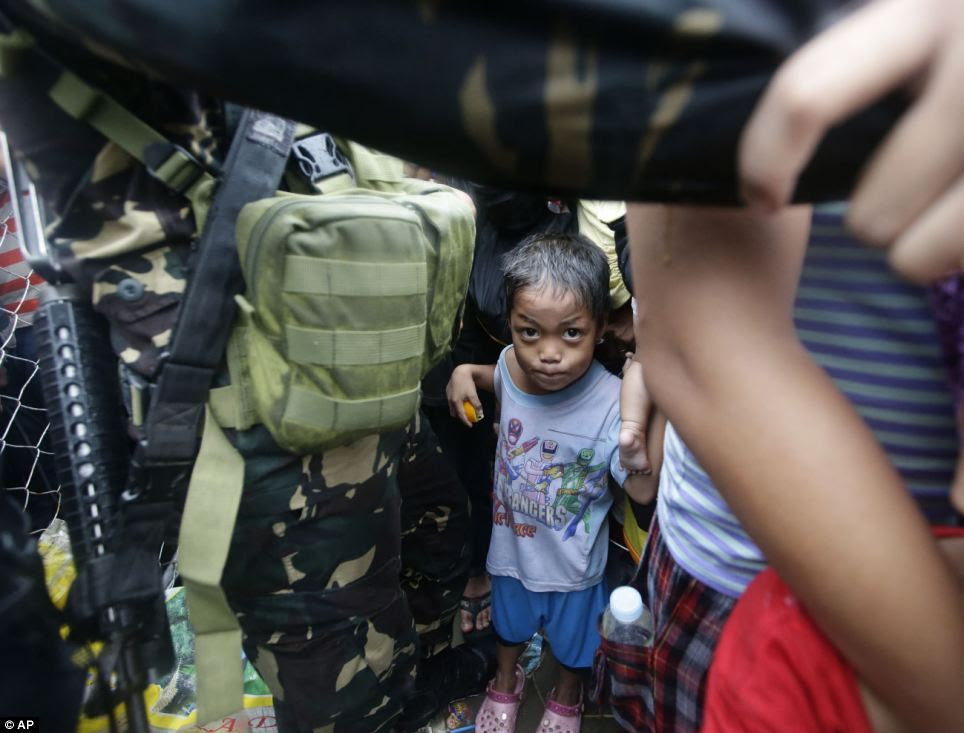 Wanting out: Thousands of typhoon survivors swarmed the airport on Tuesday seeking a flight out, but only a few hundred made it
