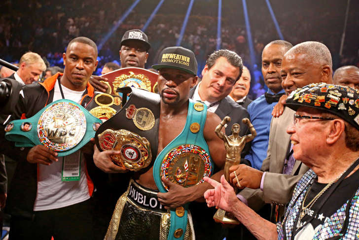 Floyd Mayweather Jr celebrates with the championship belts after defeating Manny Pacquiao (not pictured) after 12 rounds in a unanimous judges decision during a boxing fight at the MGM Grand Garden Arena on May 2 in Las Vegas.