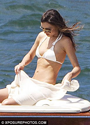 What a figure: The model was seen showing off her amazing figure as she arranged the sarong