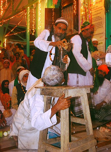 Hardcore Cheek Piercing Attached to a Stool - breaking a coconut by firoze shakir photographerno1