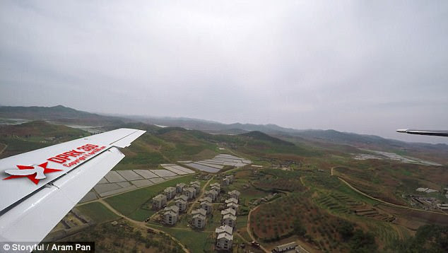Another region of the city shows vast rolling hills with small houses in rows. The region sits just outside the metropolis city