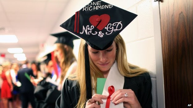 Laura Jordan wears a red ribbon with her hat decorated with initials of Natalie Lewis and Ginny Doyle before the University of Richmond's Commencement Ceremony in Richmond, Virginia 11 may 2014