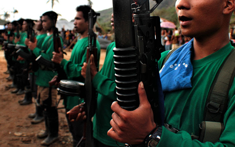 Communist guerillas sing Internationale during an activity last March in one of the villages of Compostela Valley province. (davaotoday.com file photo by Ace R. Morandante)