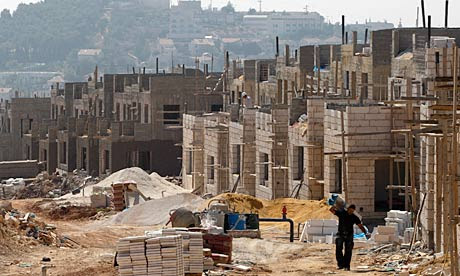 A labourer walks through a construction site in West Bank settlement of Elazar