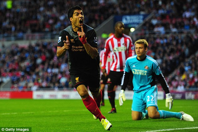 Point made: Suarez wheels away after scoring 