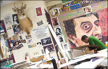 In an art room filled with students' works and props used in drawing exercises, ninth-grader Marcus Hinds works at a drawing table. Students in the visual arts magnet program at Einstein High School spend much as 2-and-a-quarter hours in it.
