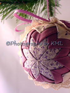 a quilted handmade christmas ornament hanging from the tree
