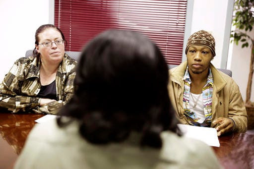 In this Thursday, March 3, 2016, photo, Nino Alexander, of Lithonia, Ga., right, and Sabrina Britt, of Clarkston, Ga., left, interview for a job with Sweet Tomatoes restaurant general manager Valerie Zimmerman during a recruiting event at the Georgia Department of Labor office in Atlanta. On Friday, March 4, the U.S. government issues the February jobs report. (AP Photo/David Goldman)