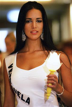 File photo of Miss Universe 2005 contestant Monica Spear of Venezuela taking part in an AIDS candlelight memorial in a Bangkok hotel