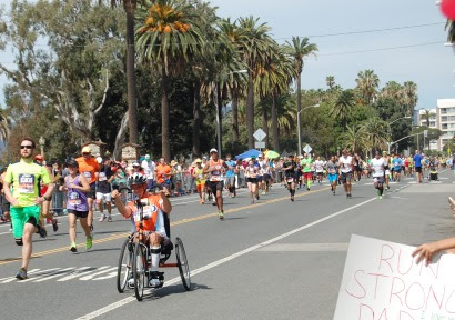 People running, about to finish 26.2 miles.