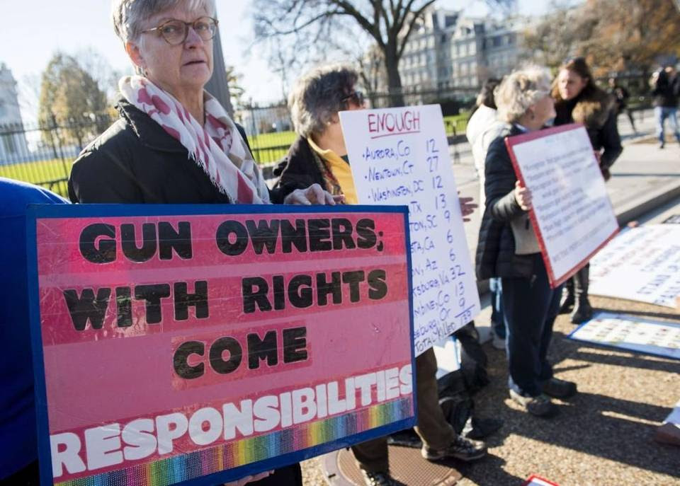 Protesters with the group “We the People for Sensible Gun Laws” rally for gun safety legislation in Washington.