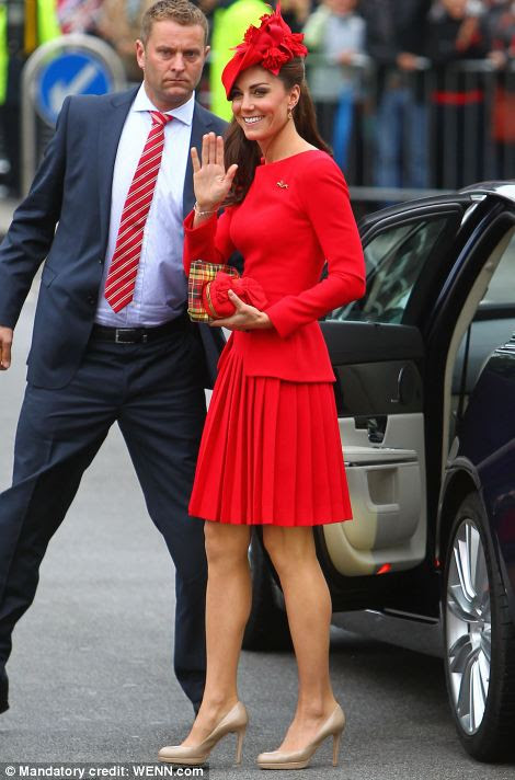 Topping off the bright outfit with a flamboyant red hat by Sylvia Fletcher from royal milliner James Lock & Co, Kate made sure the public lining the banks of the Thames would be able to spot her easily aboard the barge.